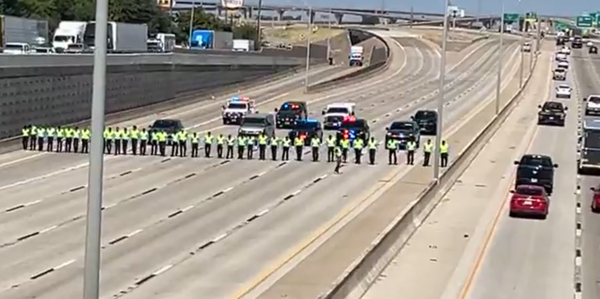 Fort Worth police cadets line up to search for evidence after an Everman ISD teacher’s aide was killed in a road rage shooting in the eastbound lanes of I-20 on Thursday morning, Aug. 13, 2026.